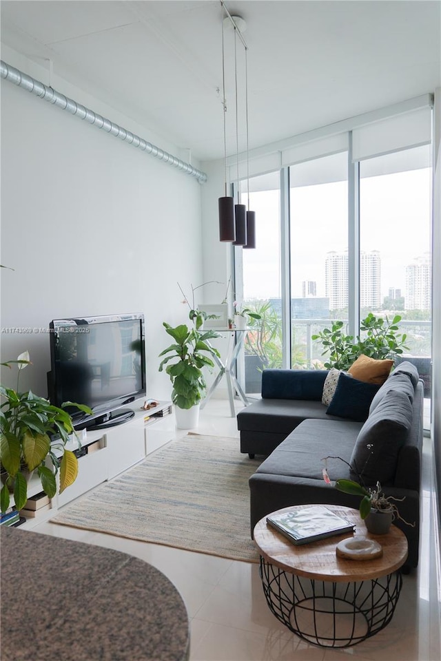 living room featuring expansive windows, tile patterned floors, and a city view