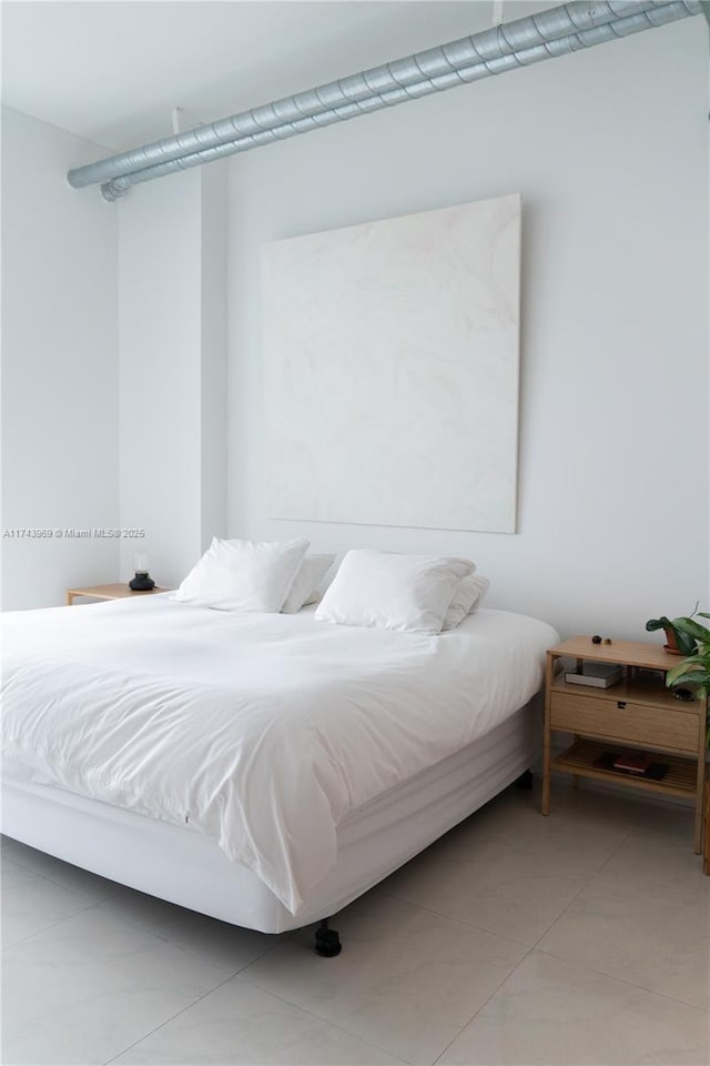 bedroom with light tile patterned flooring