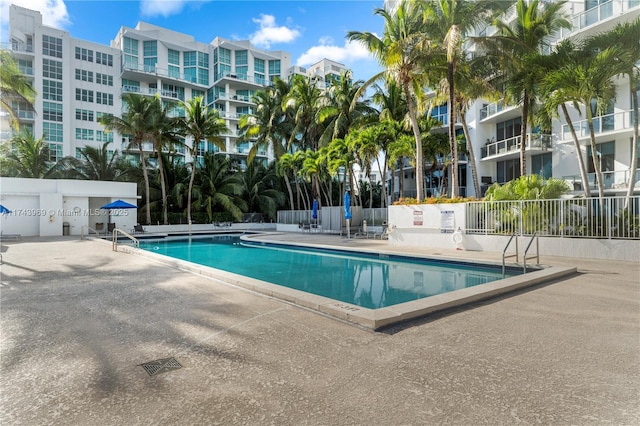 pool featuring a patio and fence
