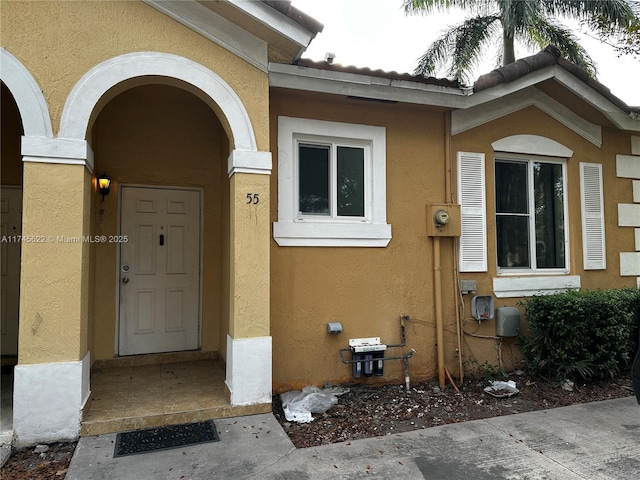 doorway to property with stucco siding