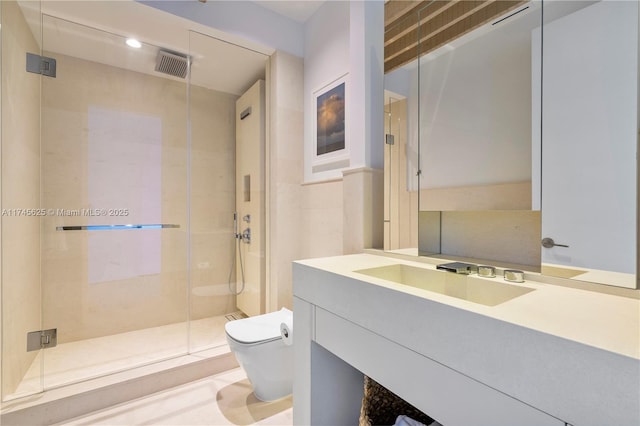 bathroom with a shower with door, vanity, and toilet