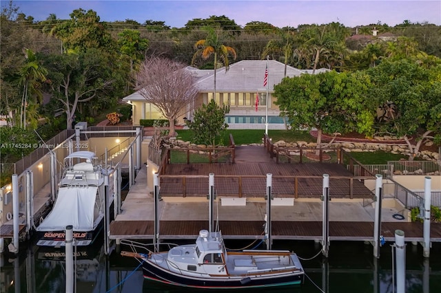 dock area featuring fence and boat lift