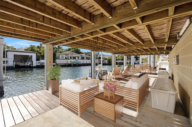 view of dock with outdoor lounge area and a water view