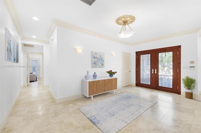 foyer entrance featuring ornamental molding and french doors