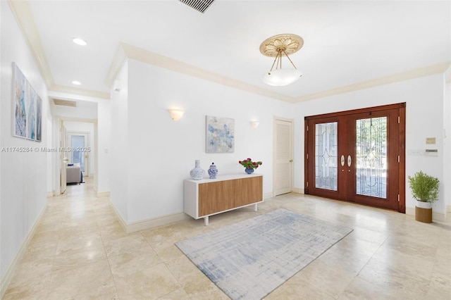 foyer entrance with french doors, baseboards, ornamental molding, and visible vents