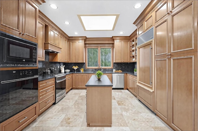 kitchen with tasteful backsplash, glass insert cabinets, a center island, dark countertops, and appliances with stainless steel finishes