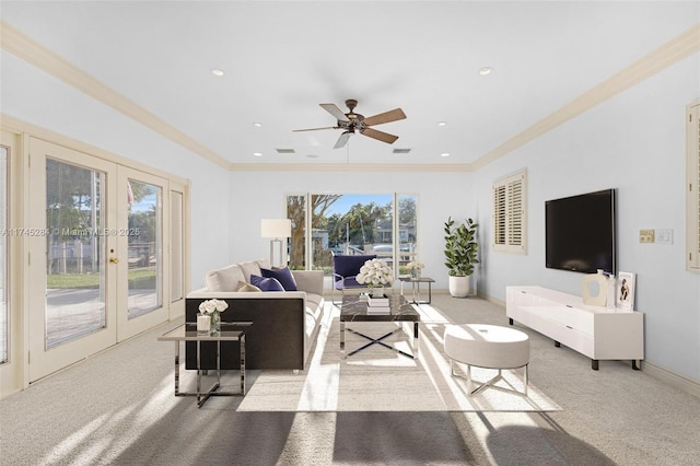 living room with french doors, crown molding, light colored carpet, and ceiling fan