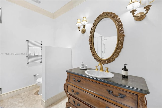 bathroom featuring vanity, baseboards, ornamental molding, toilet, and visible vents