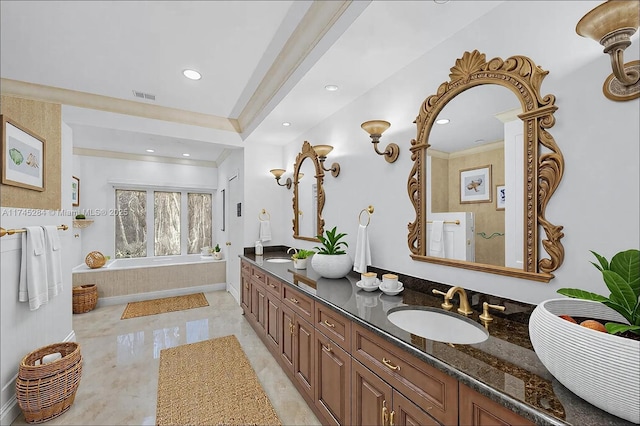 full bath with a sink, visible vents, double vanity, and a garden tub