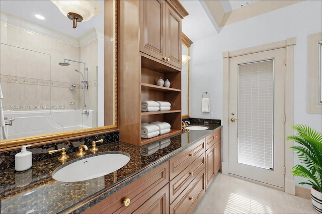 bathroom featuring a sink, tile patterned flooring, a shower, and double vanity