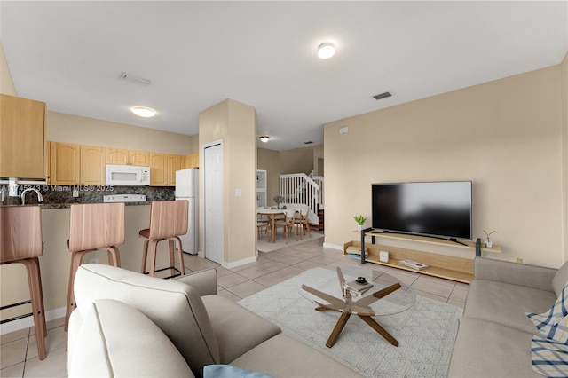 living room with sink and light tile patterned floors