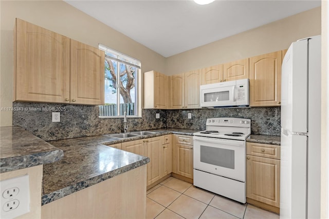 kitchen featuring light brown cabinetry, sink, white appliances, and backsplash