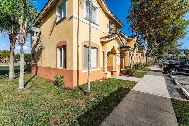 view of side of home featuring a yard