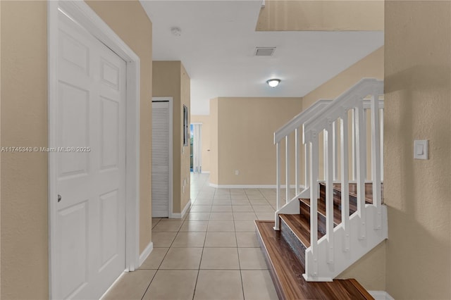 hall with light tile patterned floors