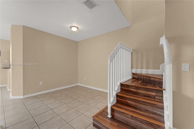 stairs featuring tile patterned floors