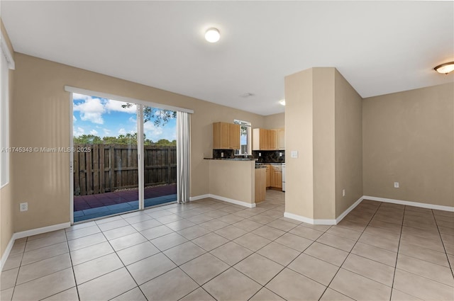 unfurnished living room with light tile patterned flooring