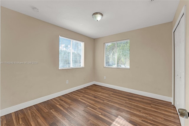 unfurnished bedroom featuring dark hardwood / wood-style flooring and a closet