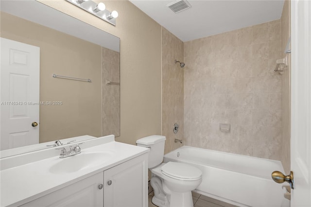 full bathroom featuring tiled shower / bath combo, vanity, tile patterned flooring, and toilet