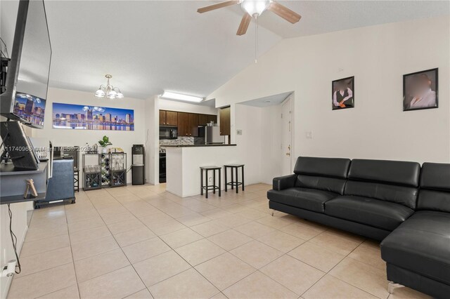 2866 S University Dr Unit 5307, Davie, FL 33328 - living area featuring ceiling fan with notable chandelier, light tile patterned floors, and vaulted ceiling