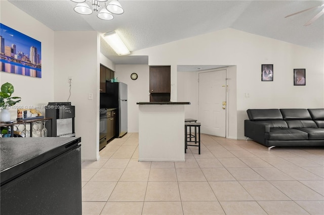 2866 S University Dr Unit 5307, Davie, FL 33328 - kitchen with black electric range oven, dark countertops, open floor plan, a breakfast bar area, and vaulted ceiling