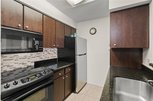 2866 S University Dr Unit 5307, Davie, FL 33328 - kitchen with a sink, dark stone counters, decorative backsplash, light tile patterned floors, and black appliances