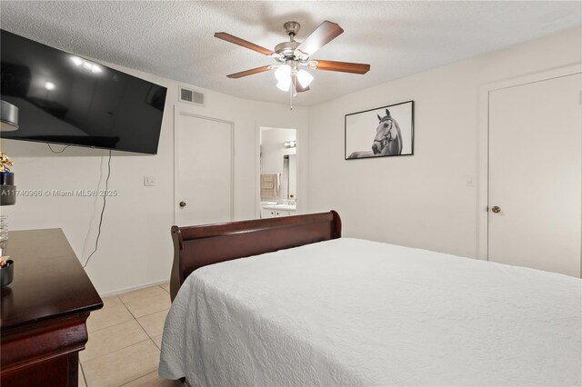 2866 S University Dr Unit 5307, Davie, FL 33328 - bedroom with connected bathroom, ceiling fan, a textured ceiling, light tile patterned floors, and visible vents