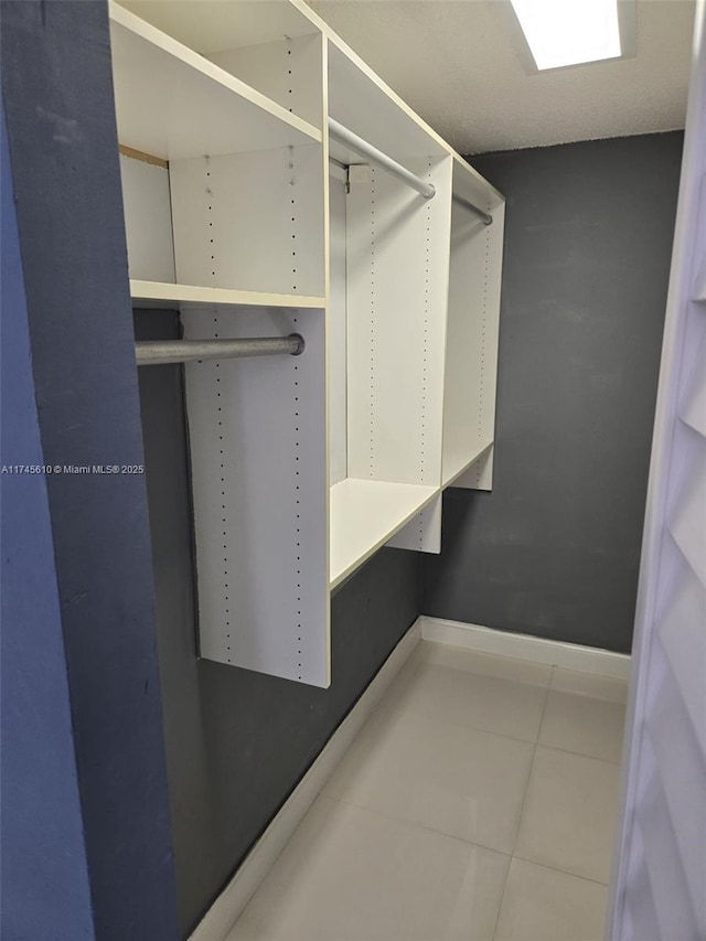 spacious closet featuring tile patterned flooring