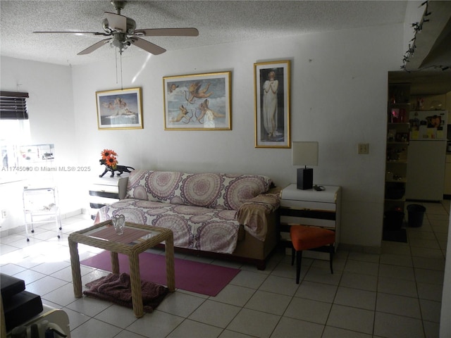 tiled living room with ceiling fan and a textured ceiling