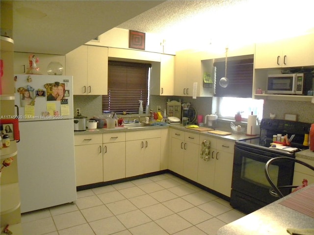 kitchen with white cabinetry, white refrigerator, tasteful backsplash, light tile patterned flooring, and black range with electric cooktop