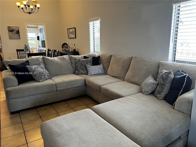 living room featuring a chandelier, light tile patterned floors, and plenty of natural light