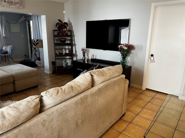 tiled living area featuring baseboards