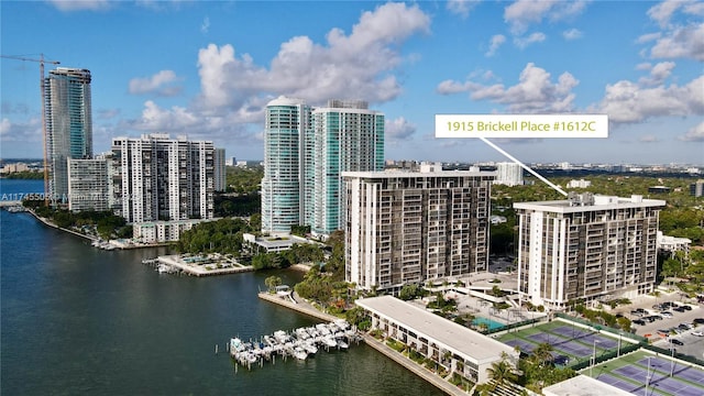 birds eye view of property with a water view and a view of city