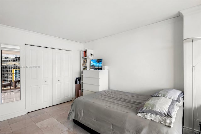 bedroom featuring a closet and crown molding