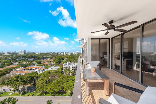 balcony featuring a city view and a ceiling fan