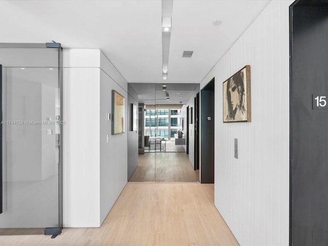 corridor with visible vents and light wood-style floors