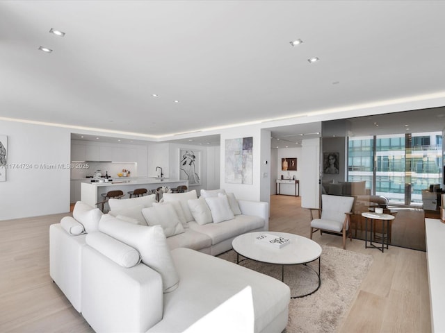 living room with recessed lighting and light wood-style flooring