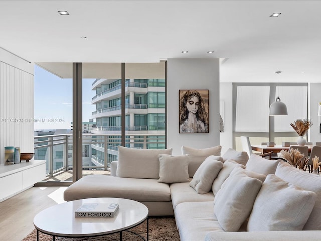 living area featuring a wall of windows and wood finished floors