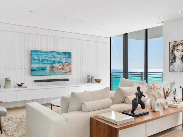 living area featuring a water view and light wood-style flooring