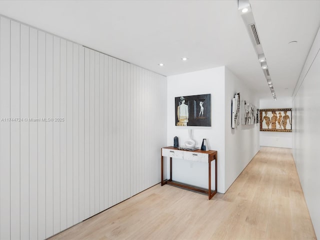 hall featuring light wood finished floors and recessed lighting