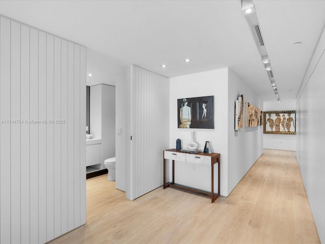 hall with recessed lighting and light wood-style floors