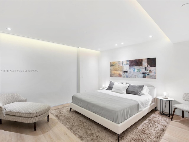 bedroom with light wood-type flooring and recessed lighting