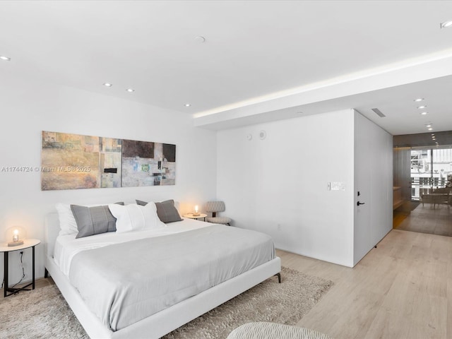 bedroom featuring recessed lighting, visible vents, and light wood finished floors