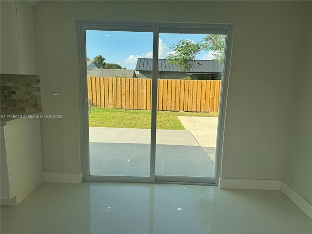 doorway featuring light tile patterned flooring