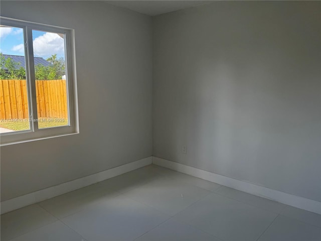 unfurnished room featuring light tile patterned flooring