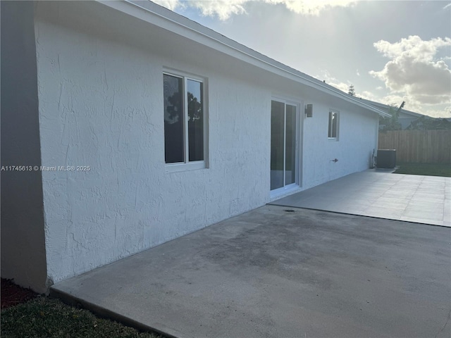 rear view of house with a patio and cooling unit