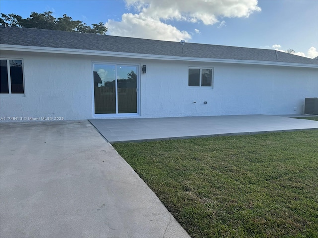 rear view of property featuring cooling unit, a patio area, and a lawn