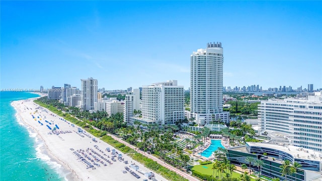 birds eye view of property with a view of the beach and a water view