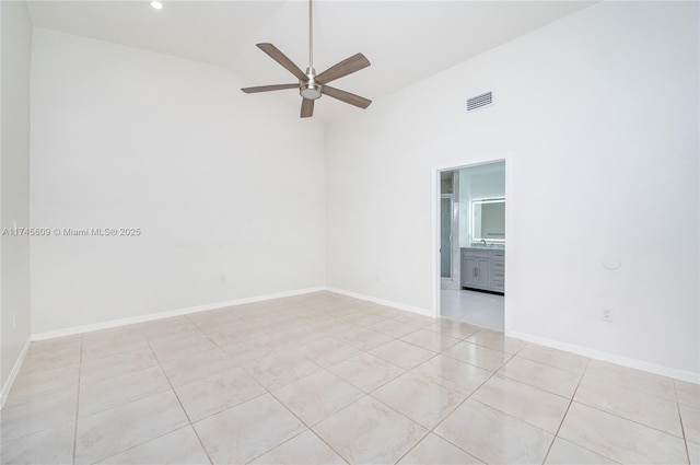 tiled empty room featuring ceiling fan and lofted ceiling