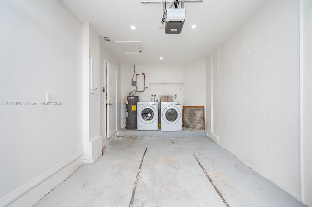 clothes washing area featuring water heater and washer and dryer