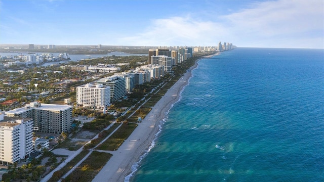 drone / aerial view featuring a water view and a beach view